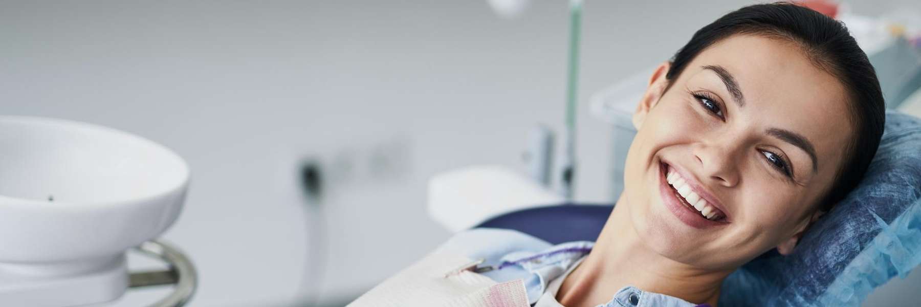 woman in a dental chair smiling